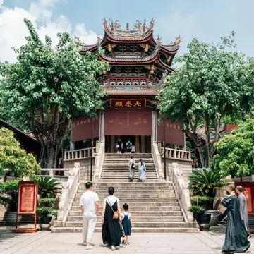 Visitors approach the steps to a temple in Xiamen.