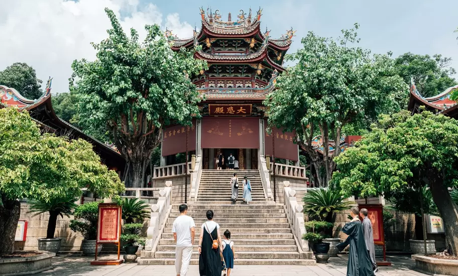 Visitors approach the steps to a temple in Xiamen.