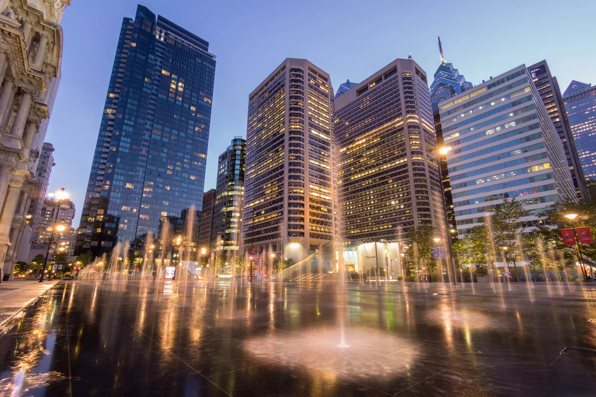Fountains at Dilworth Plaza in Center City Philadelphia at dusk.