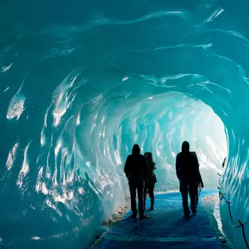Silhouettes of people visiting thee ice cave of the Mer de Glace glacier,  in Chamonix Mont Blanc Massif, The Alps, France, License Type: media, Download Time: 2025-08-20T22:48:11.000Z, User: krista950237, Editorial: false, purchase_order: 56500 - T&R or Kids, job: Global Publishing WIP, client: A Kid's Guide to France, other: Krista Rossow