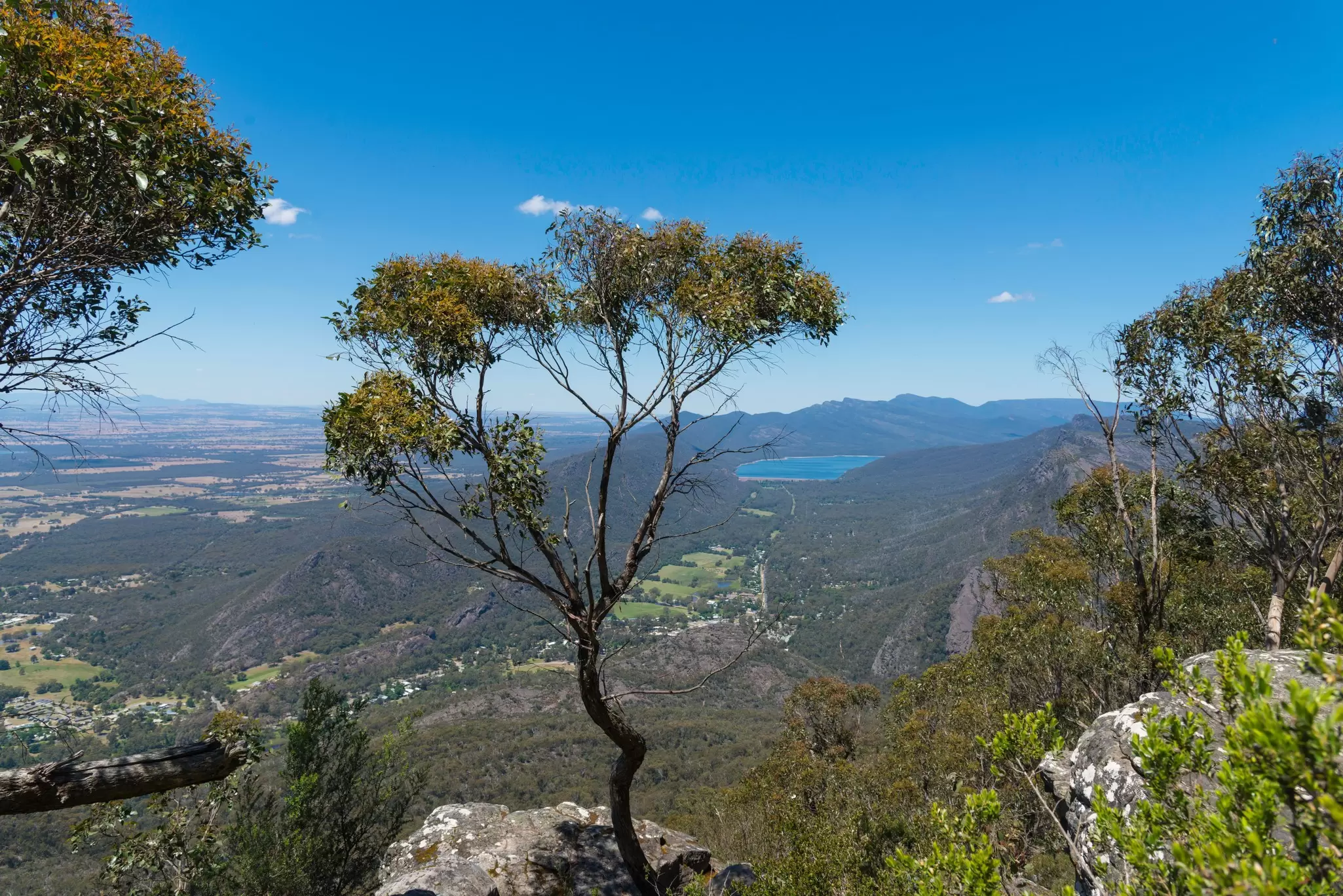 A vast landscape with a distant lake seen from a high-up viewpoint: Grampians National Park in Victoria, Australia.