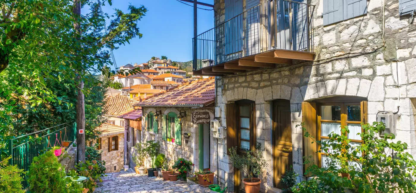 Cobblestone street with houses decorated with flower boxes