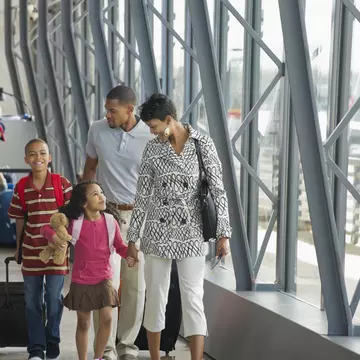 Family walking together in airport
