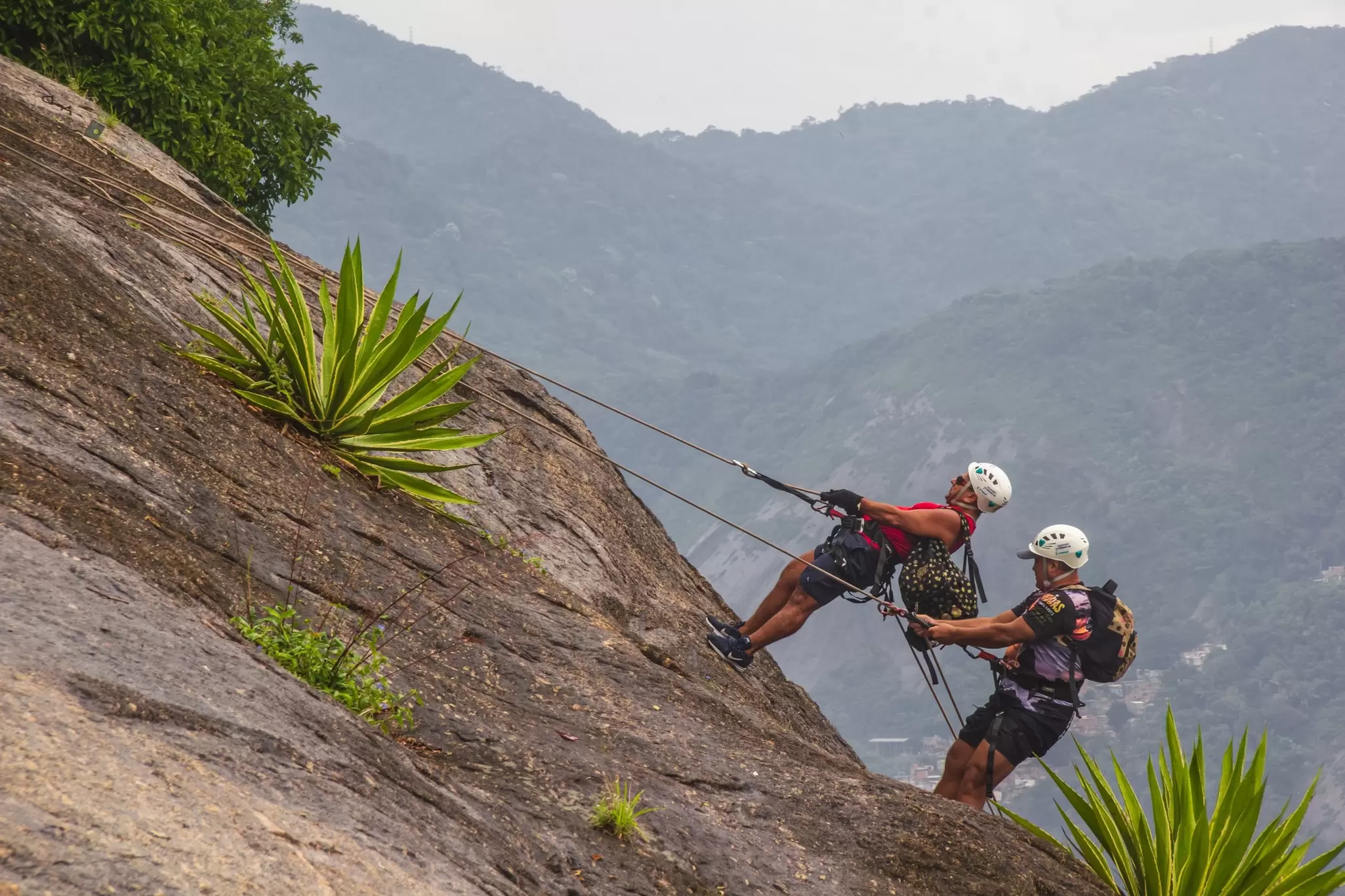 People abseiling at Sugarloaf Mountain in Rio de Janeiro, Brazil.