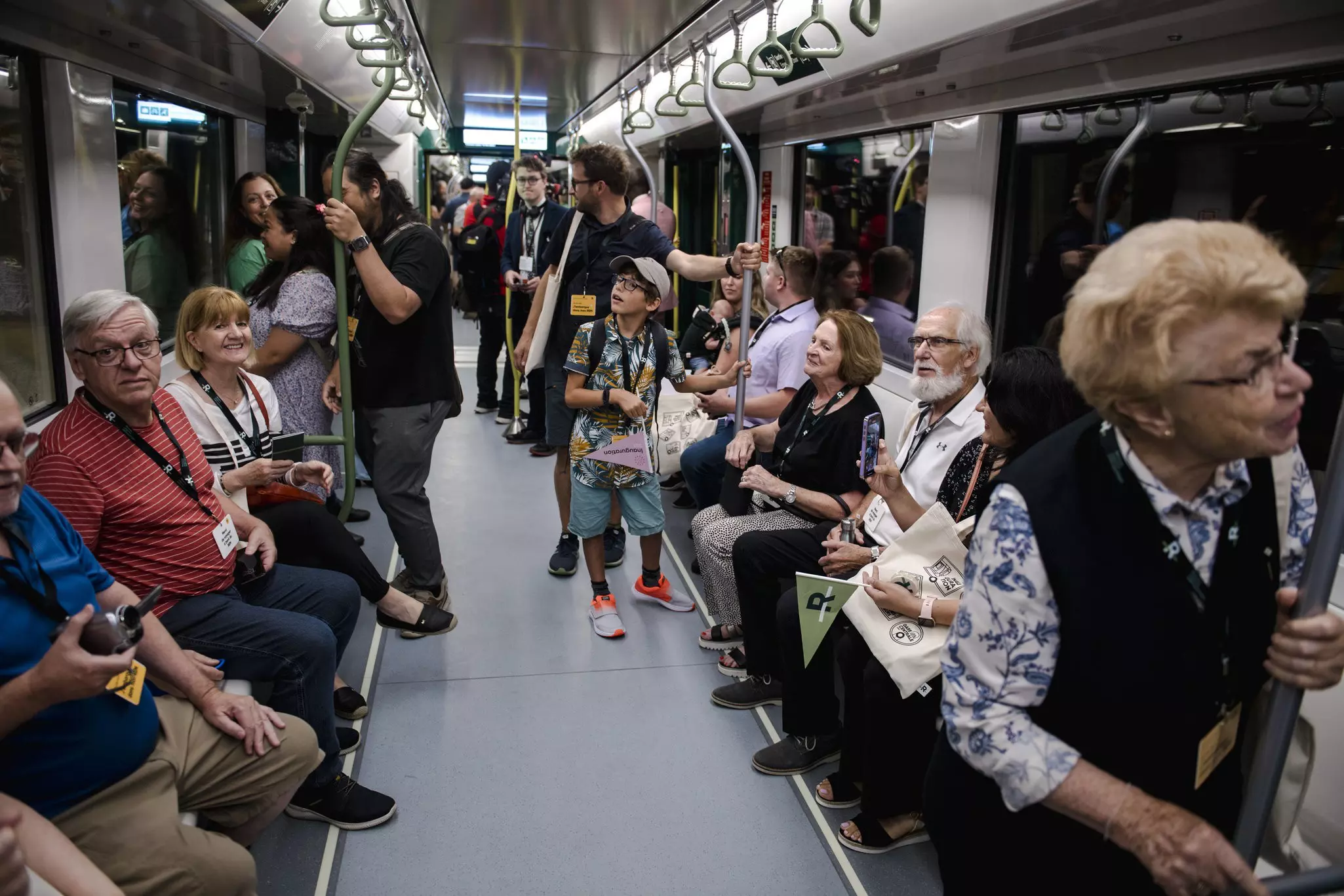 Visitors ride the Reseau Express Metropolitain (REM) light rail in Montréal, Québec, Canada