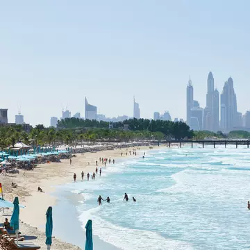 People in the water at Jumeirah Beach with the Dubai skyline in the distance ©R.A.R. de Bruijn Holding BV/Shutterstock