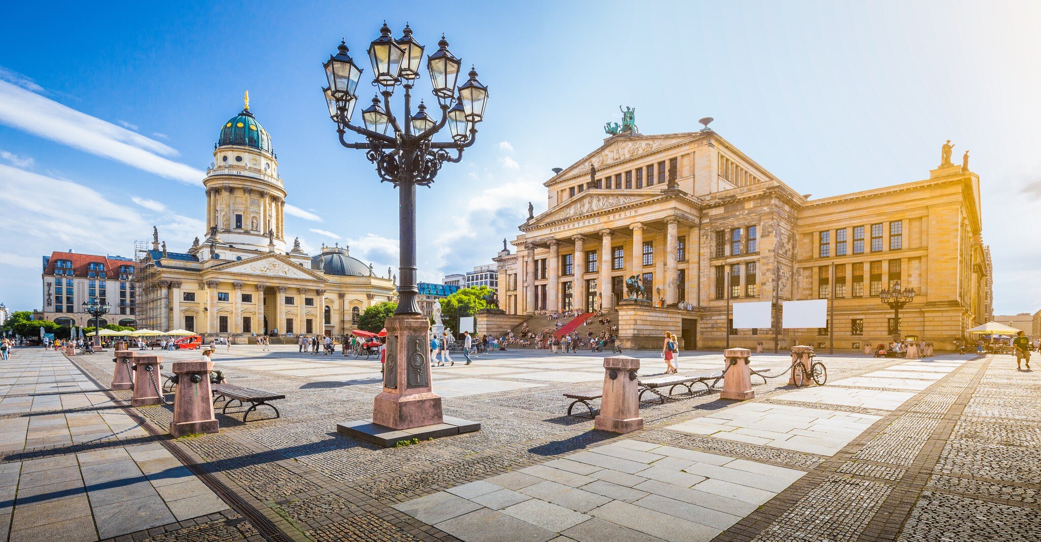 Panoramic view of famous Gendarmenmarkt square with Berlin Concert Hall and German Cathedral  at sunset.