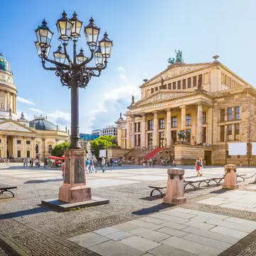 Panoramic view of famous Gendarmenmarkt square with Berlin Concert Hall and German Cathedral  at sunset.