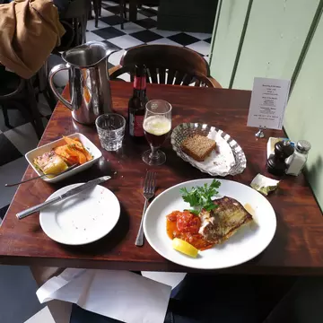 Table setting of food and beer at the Farmgate Cafe at the English Market, Cork, Ireland.