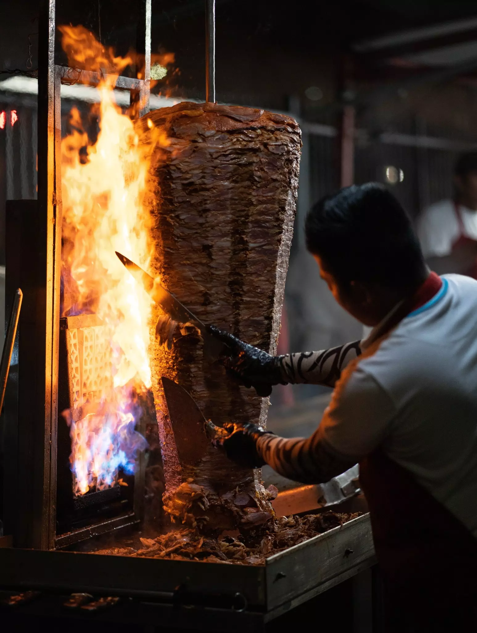 Grilling meat for al pastor tacos in Los Angeles, California, USA.