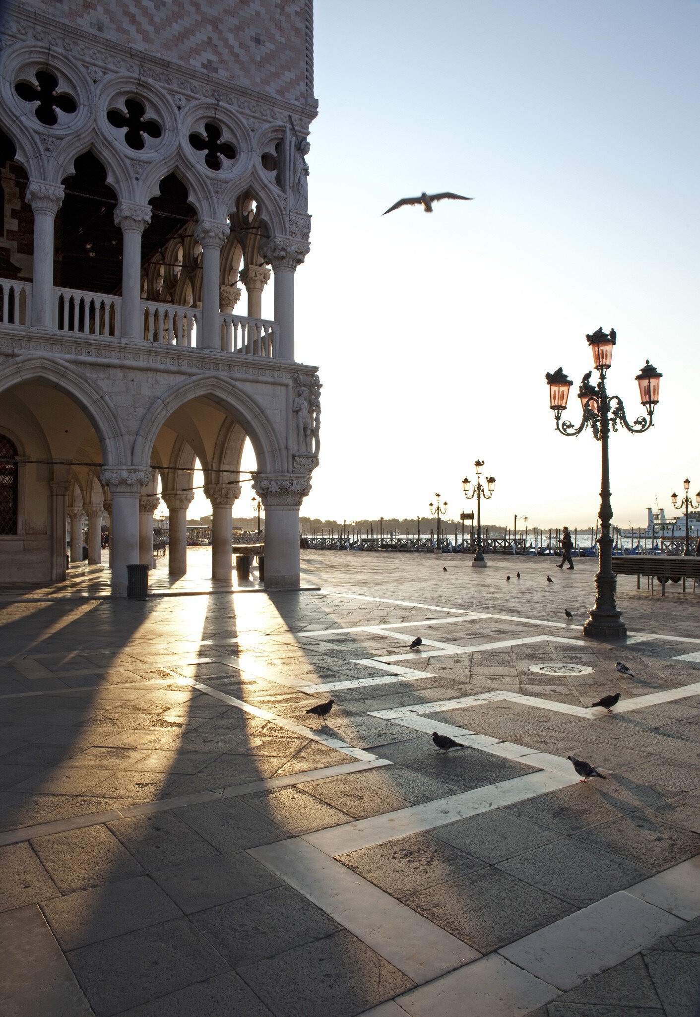 Light streaming through archways of the Palazzo Ducale on Piazza San Marco in Venice, Italy.