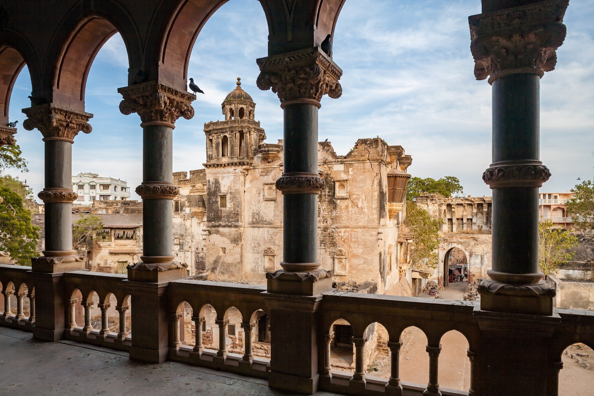 Aina Mahal and courtyard seen from a decorated balcony of Prag Mahal. Gujarat, India.