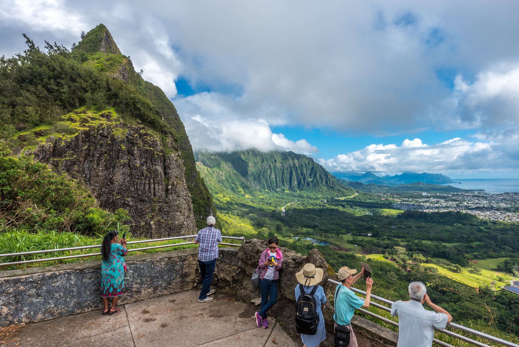 Nu'uanu, Hawaii, Oahu - May 28, 2017: tourists and island visitors gaze at the view of the winward side of oahu from the pali lookout, a section of the windward cliff of the Ko?olau mountain range