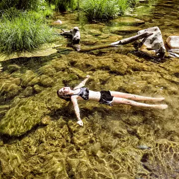 Girl floats peacefully in the clear desert water of West Clear Creek, Arizona.
699096037