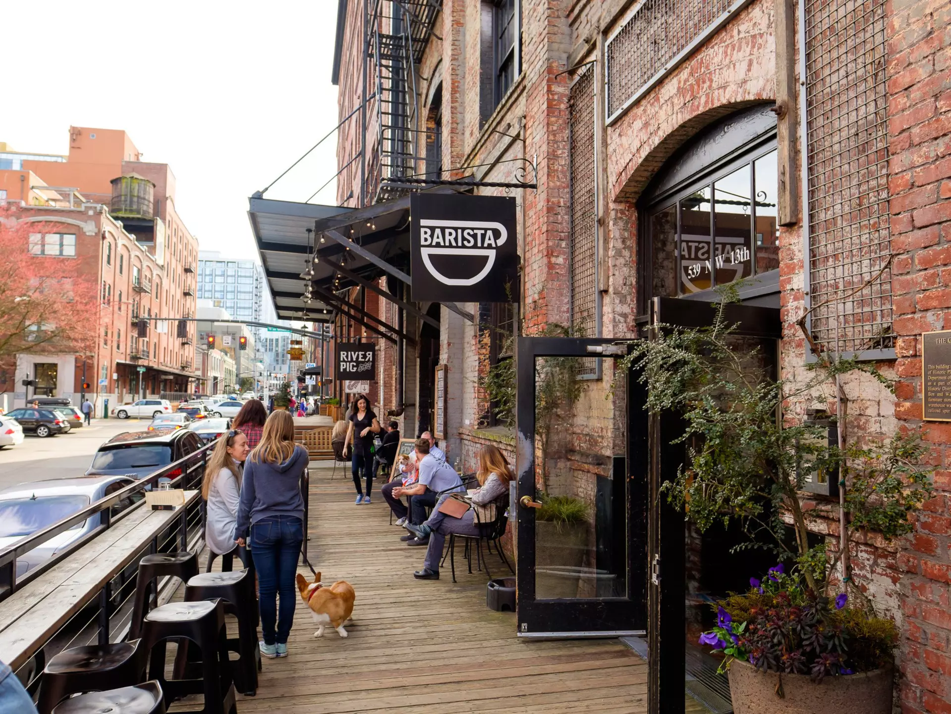 Customers and a corgi outside Barista coffee shop in Portland's Pearl District on a clear day