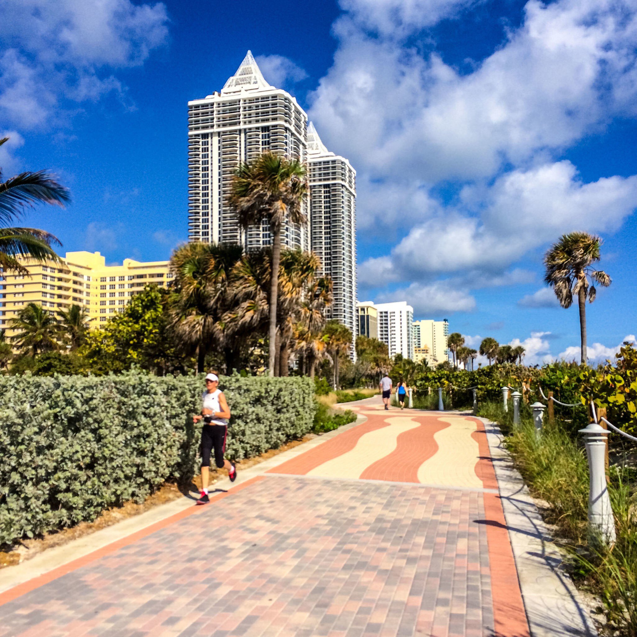 People running and walking along the Miami Beach boardwalk in Florida