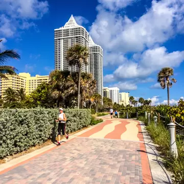 People running and walking along the Miami Beach boardwalk in Florida