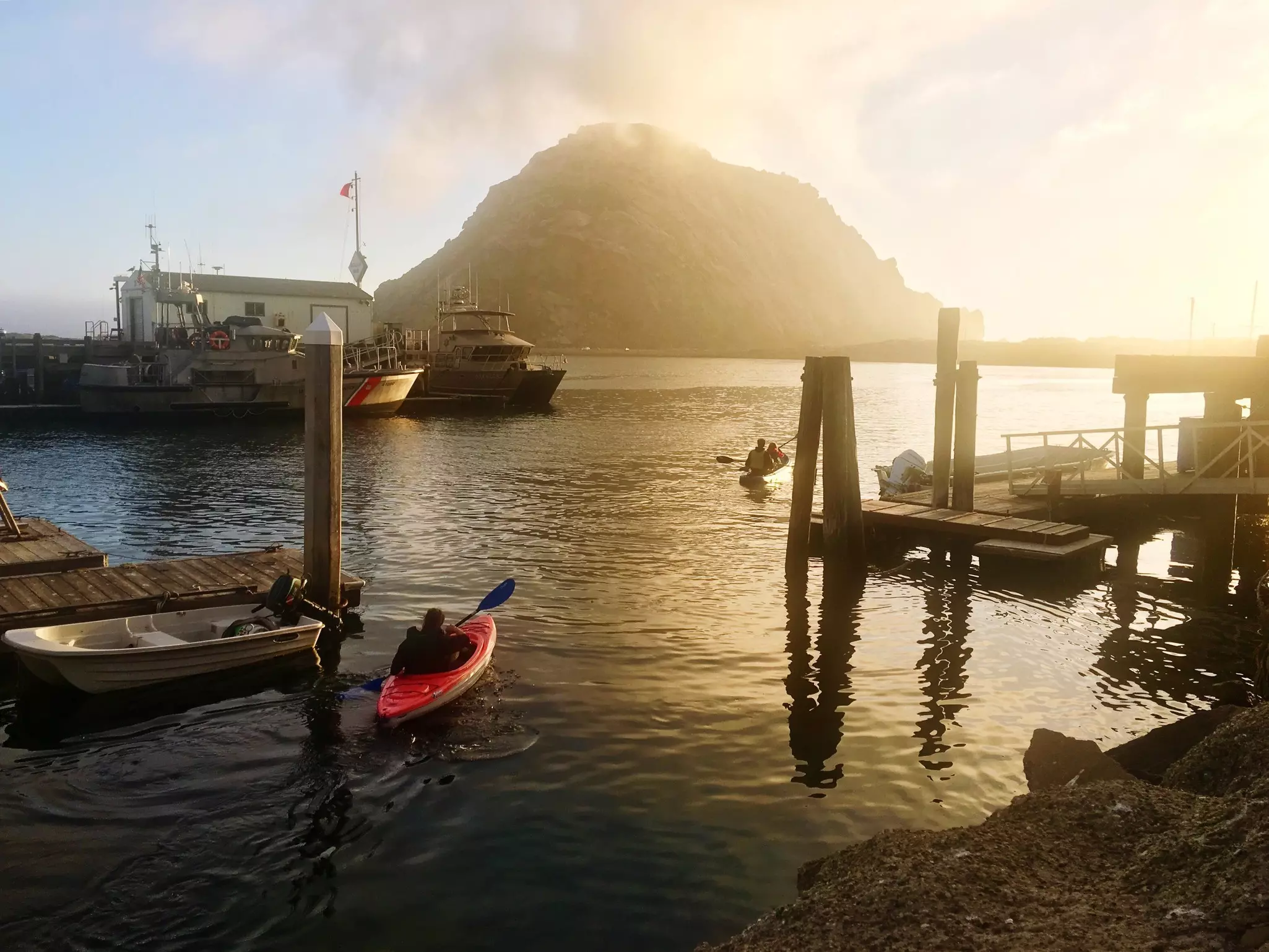 Kayakers at the docks of Morro Bay on a sunny day.