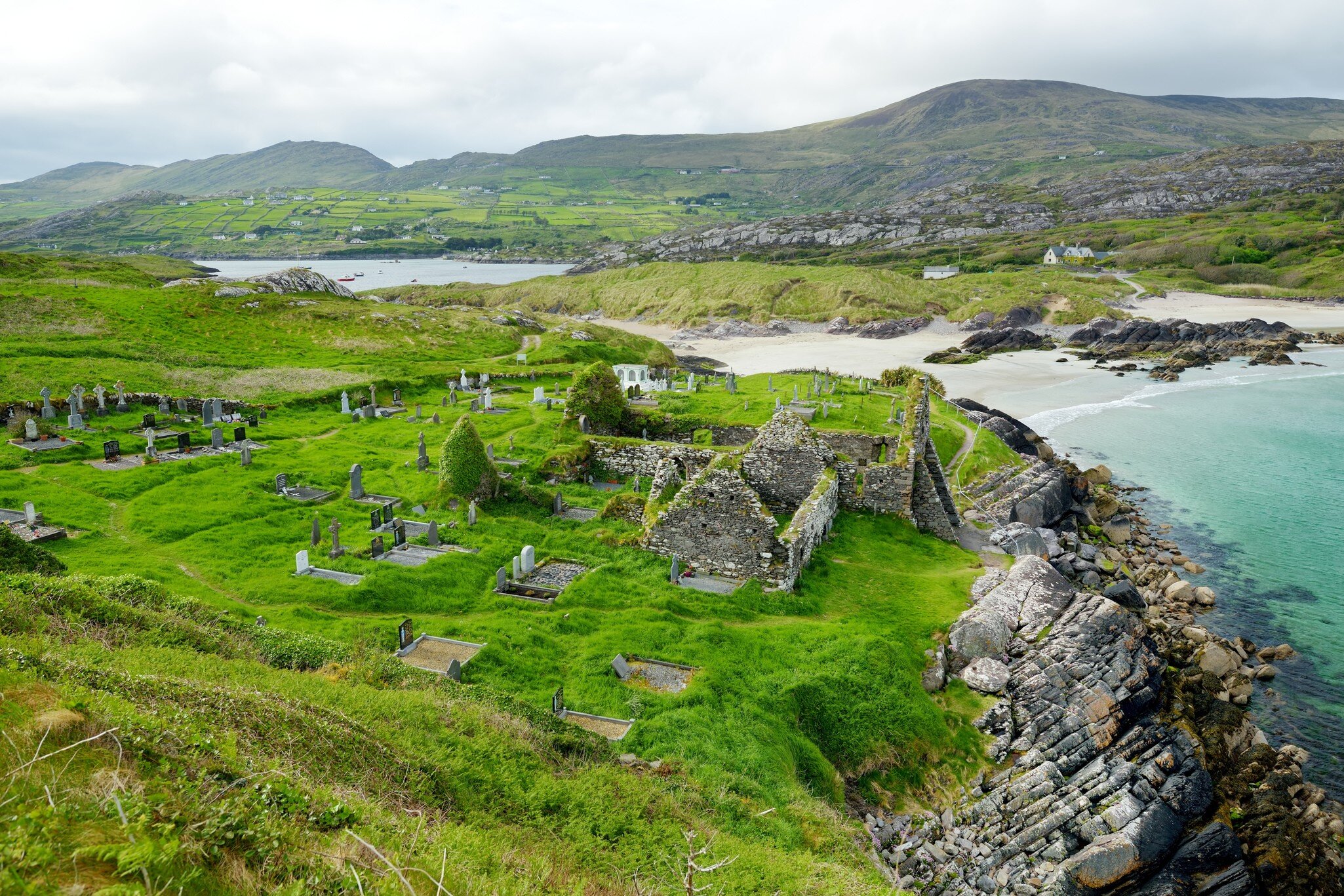 Aerial view of Abbey Island, the idyllic patch of green land in Derrynane Historic Park, famous for ruins of Derrynane Abbey and cementery, located in County Kerry, Ireland.