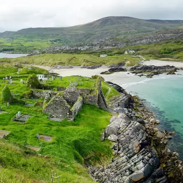 Aerial view of Abbey Island, the idyllic patch of green land in Derrynane Historic Park, famous for ruins of Derrynane Abbey and cementery, located in County Kerry, Ireland.