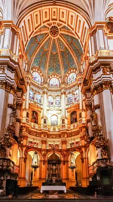 Gilded baroque interior of Granada Cathedral with ornate altar and detailed religious artwork