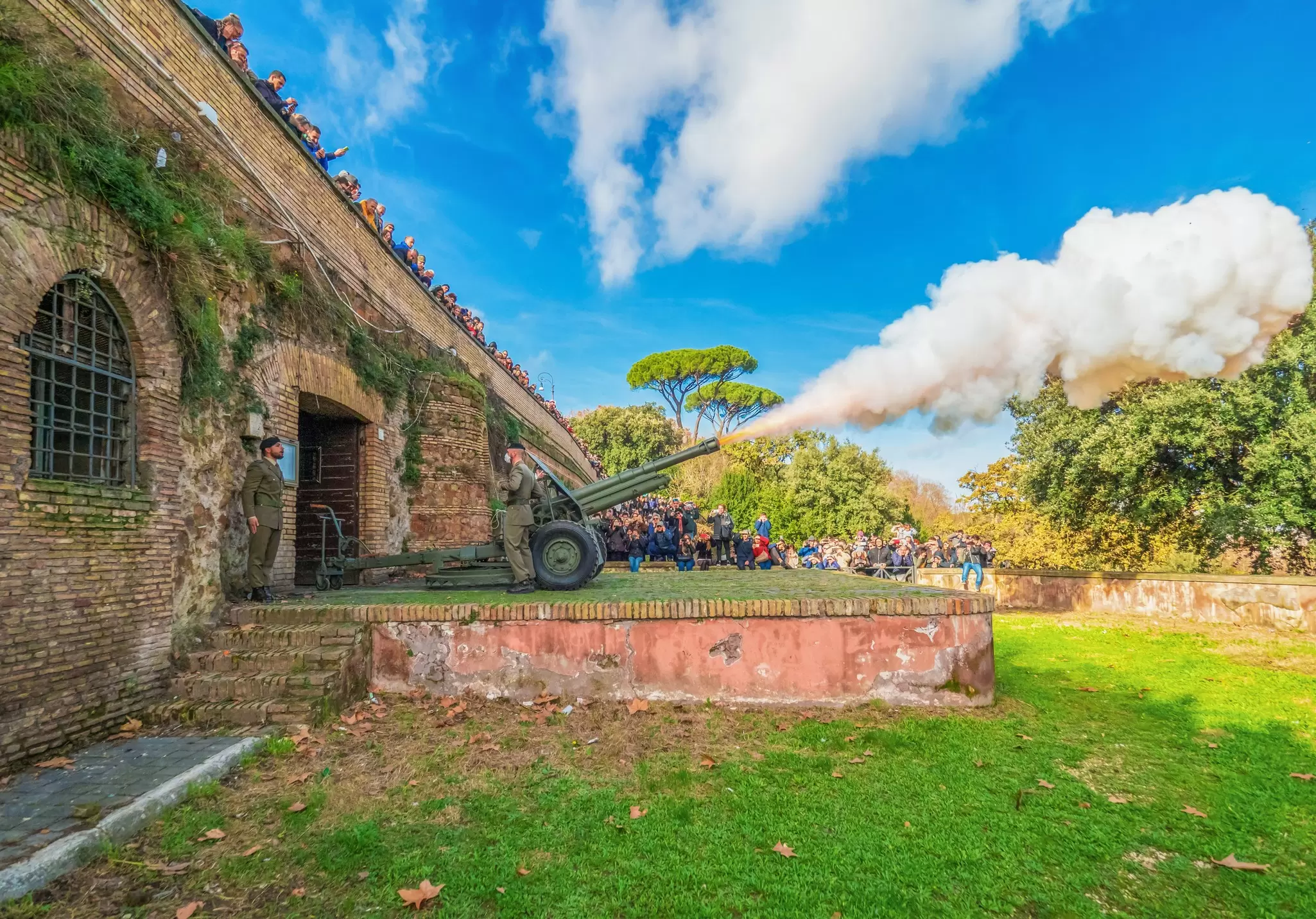 People observing a cannon explosion on Gianicolo Hill in Rome, Italy.