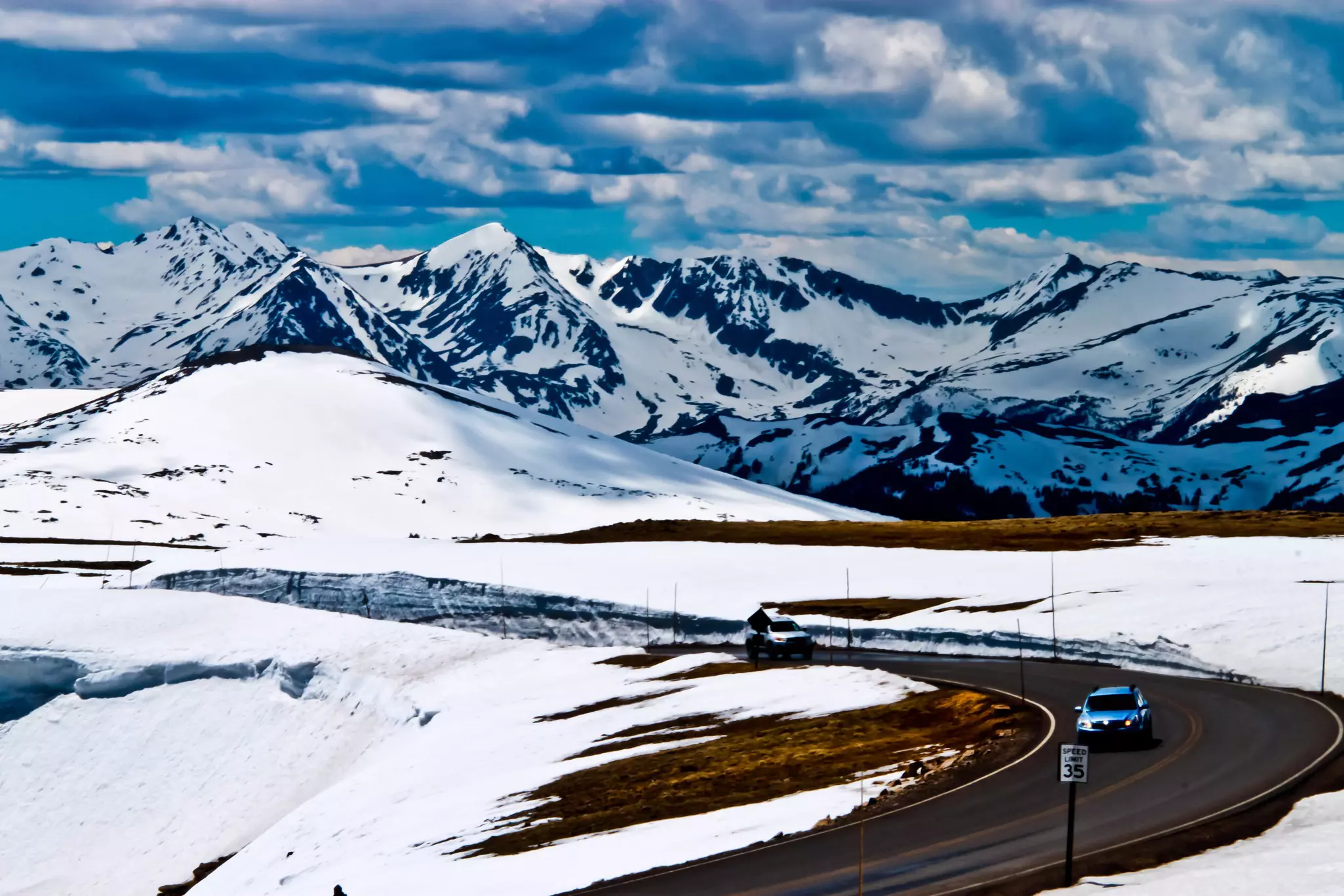 Beautiful view of trail ridge road and majestic snow capped mountains in Rocky Mountain National Park, Colorado, USA.