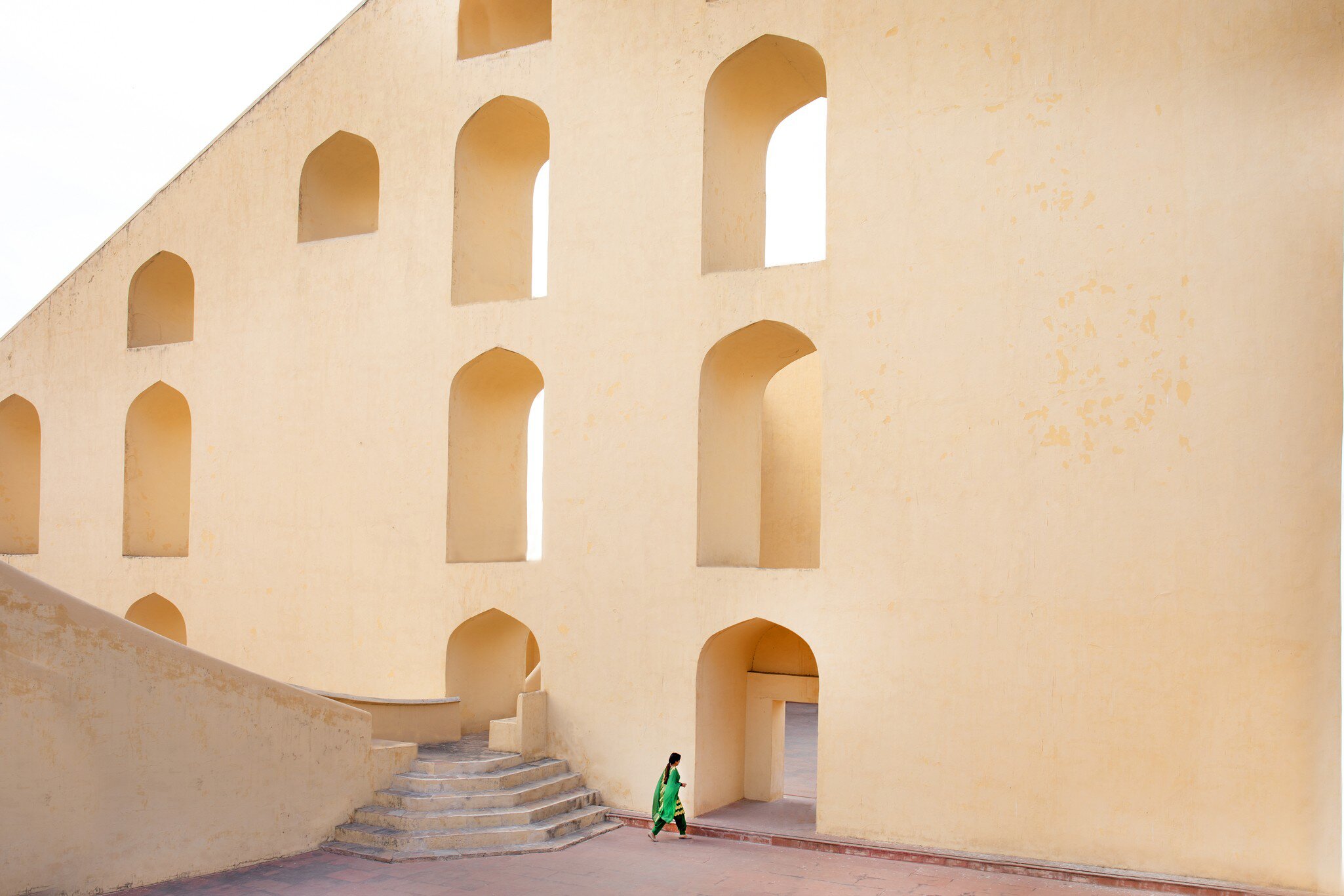 A young lady walking through the Jantar Mantar astrological park in Jaipur, India.