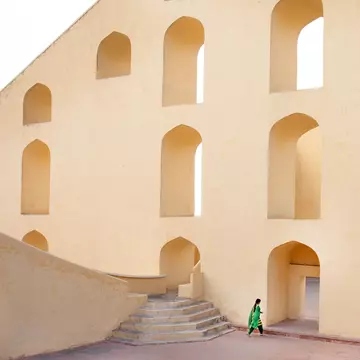 A young lady walking through the Jantar Mantar astrological park in Jaipur, India.