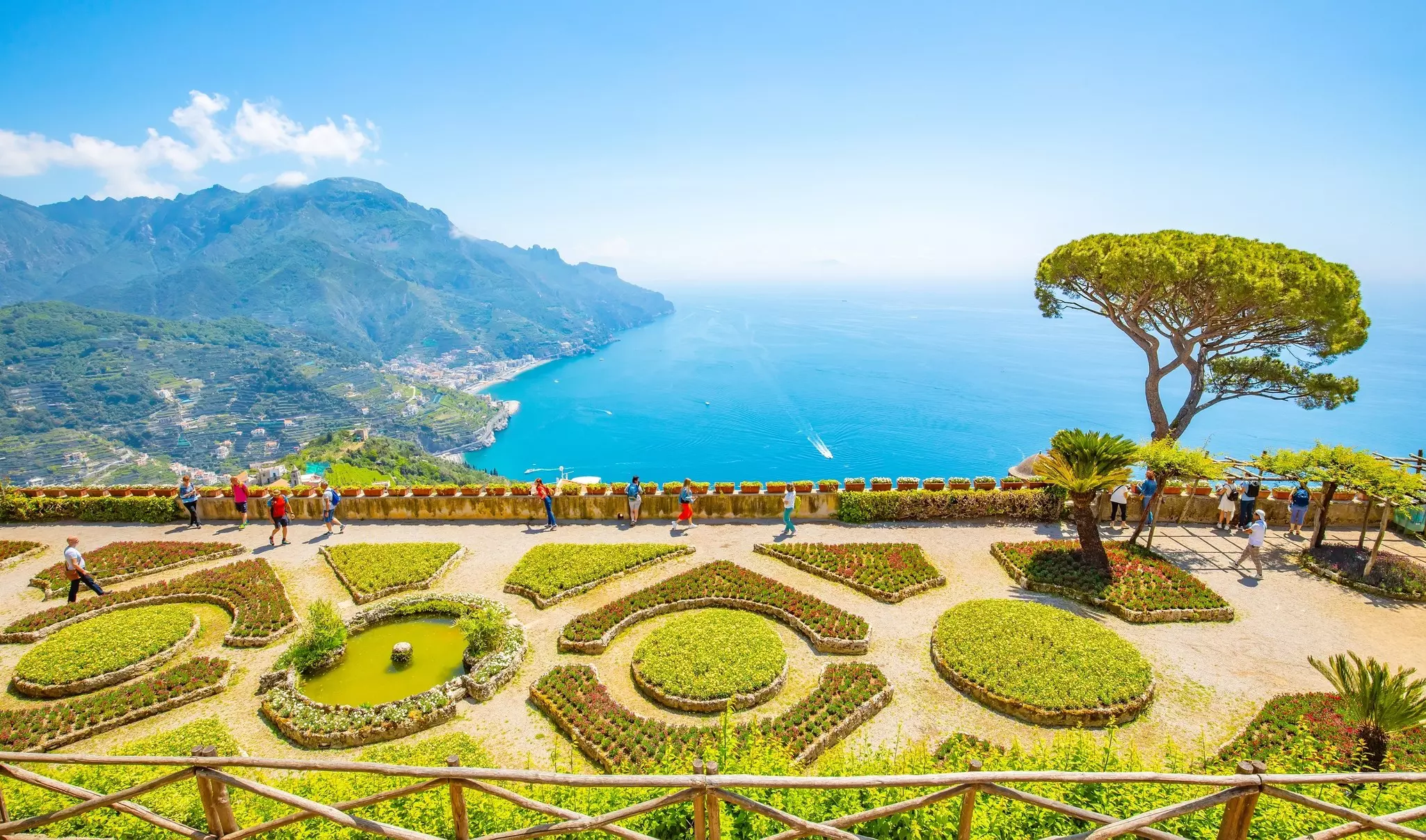 Landscaped gardens on a hilltop with the coastline stretching out into the distance.