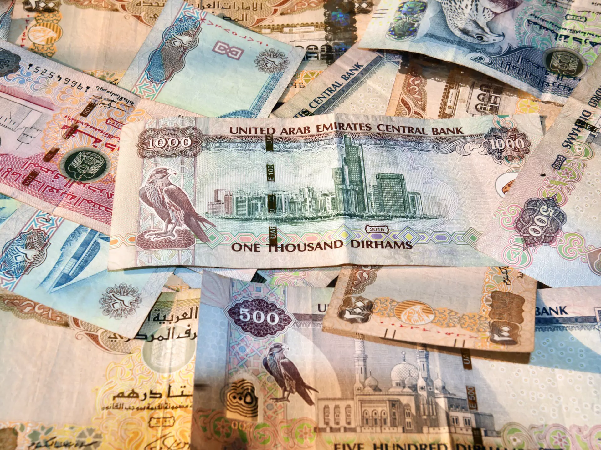 United Arab Emirates currency with notes spread on a table.
927096466
Value Added Tax, Cash, Paper Currency, Banking, Finance and Economy, Tax, Horizontal, Currency Symbol, Photography, Business, No People, Color Image, Finance, Currency, Persian Gulf Countries, Wealth, United Arab Emirates Currency, Making Money, dhiram, Commercial Activity, United Arab Emirates