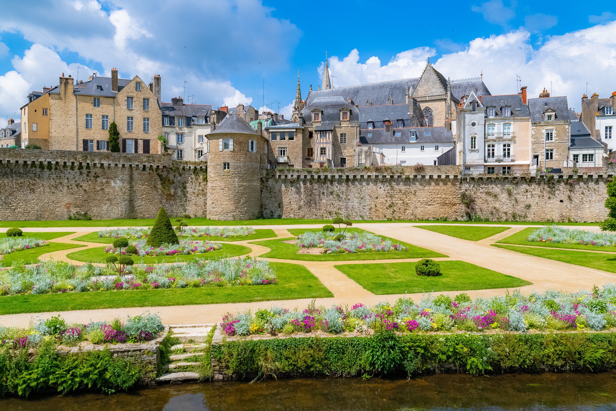 Vannes, France, May 20, 2019, medieval city in Morbihan, view of the garden of the ramparts, a public park, with the old city behind the walls