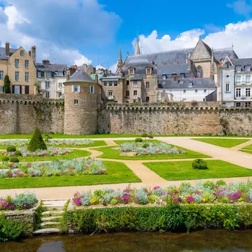 Vannes, France, May 20, 2019, medieval city in Morbihan, view of the garden of the ramparts, a public park, with the old city behind the walls