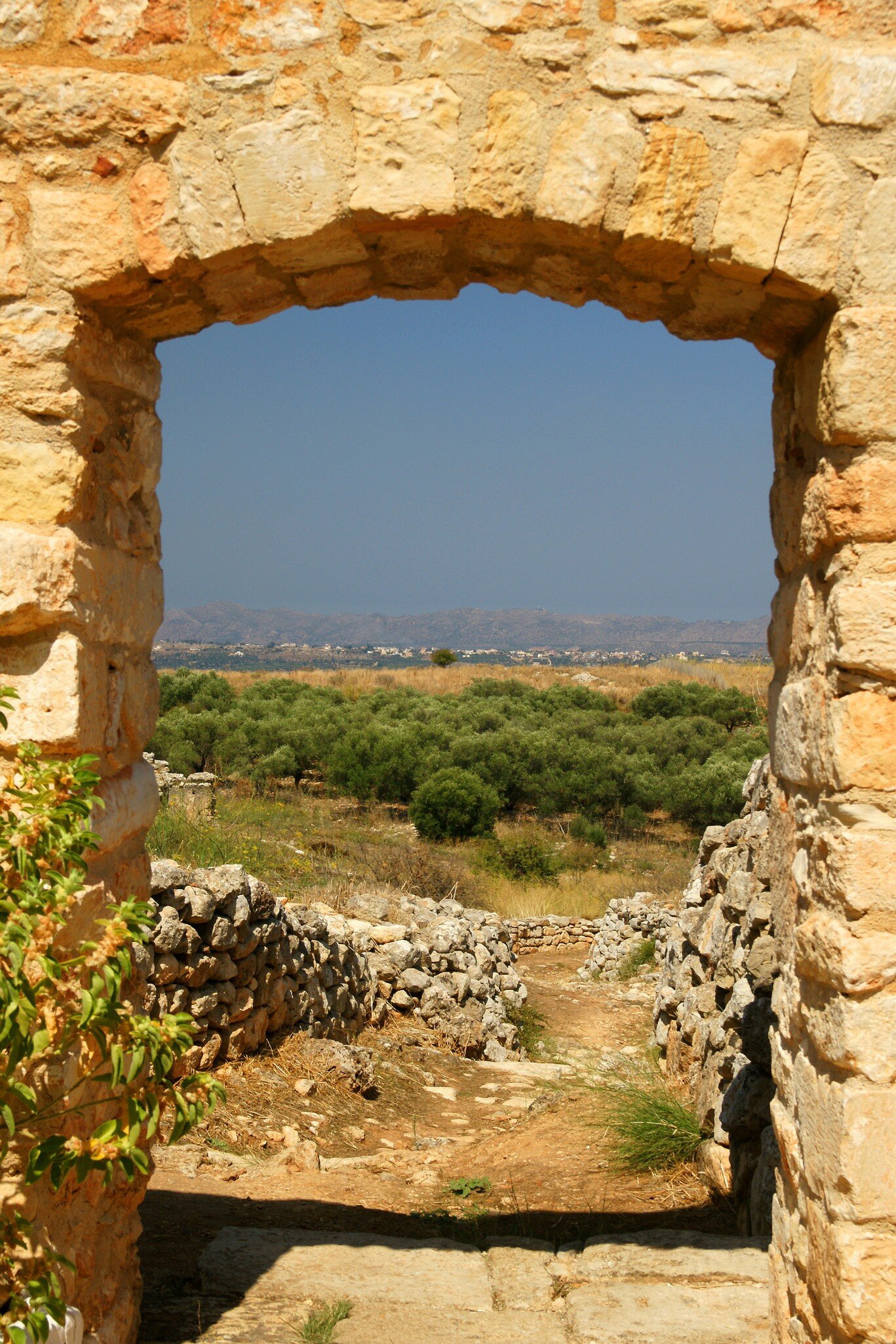 View through the frame of a stone doorway from ancient ruins in Crete looking towards the Aptera towards Souda Bay.