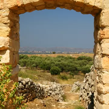 View through the frame of a stone doorway from ancient ruins in Crete looking towards the Aptera towards Souda Bay.