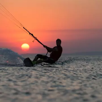 Kiteboarder at sunset off Mauritius