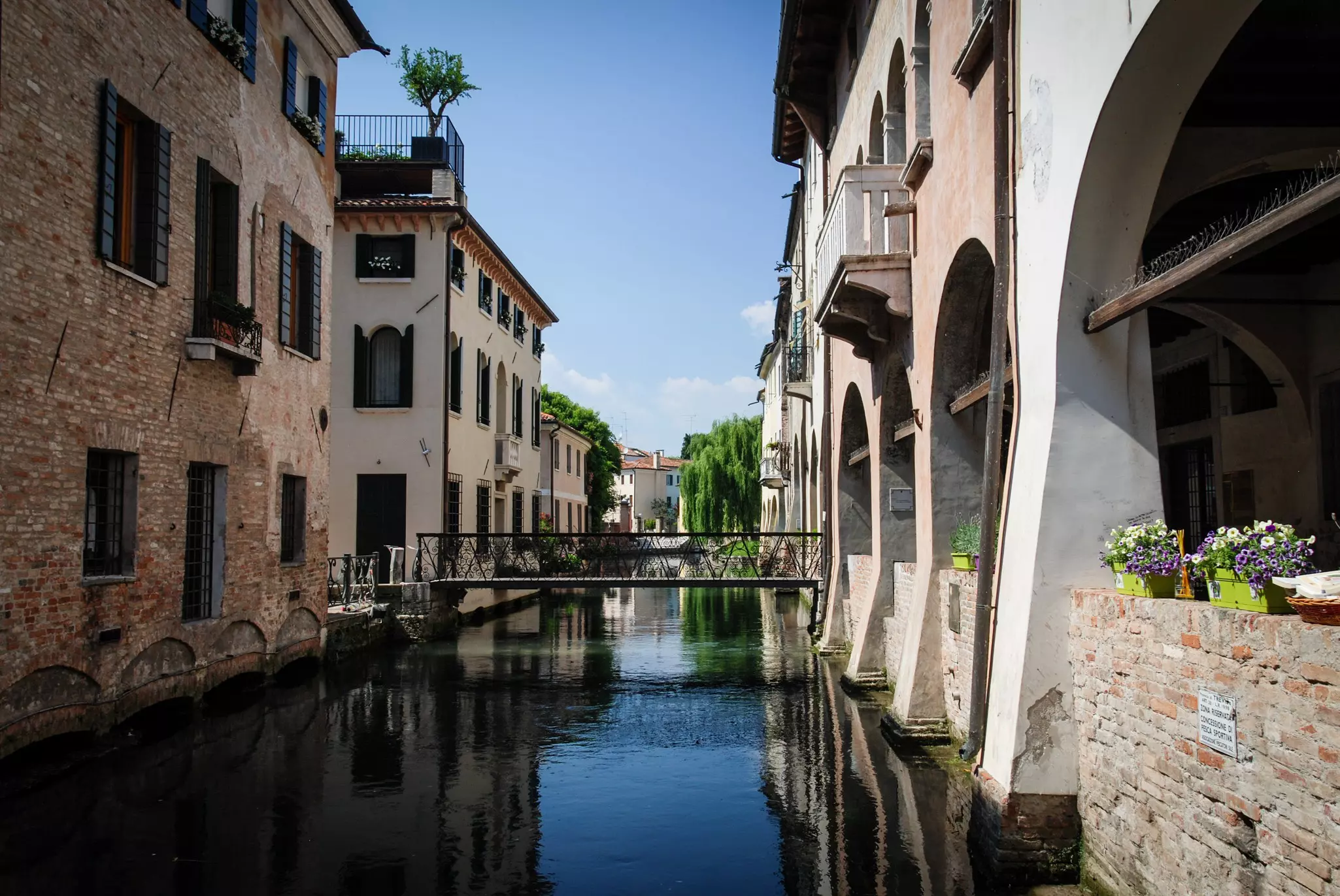 Stone buildings lining a canal in Treviso, Italy