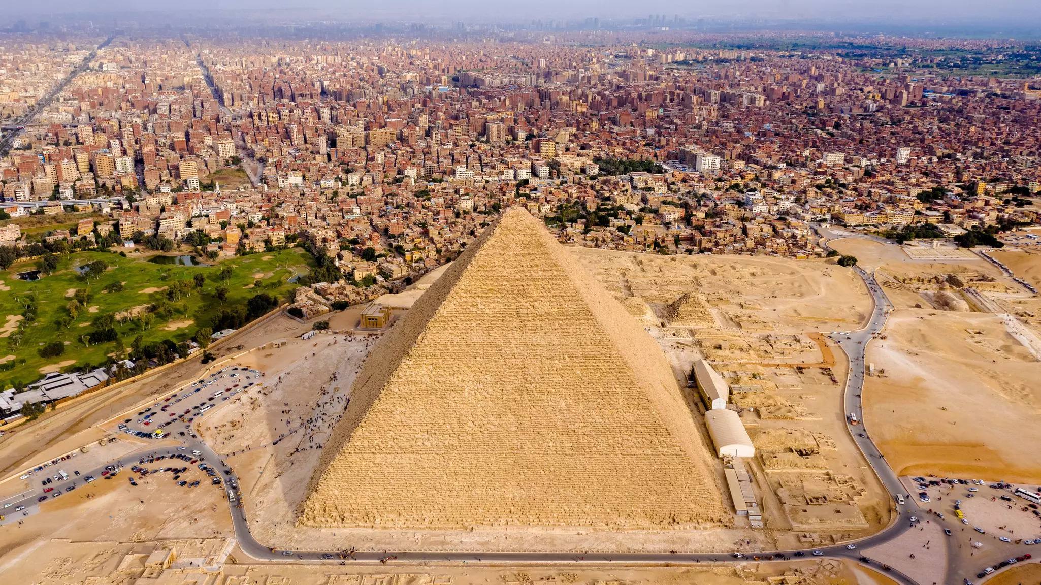 Aerial view of the Great Pyramid of Khufu in Giza, Egypt, with the city behind.