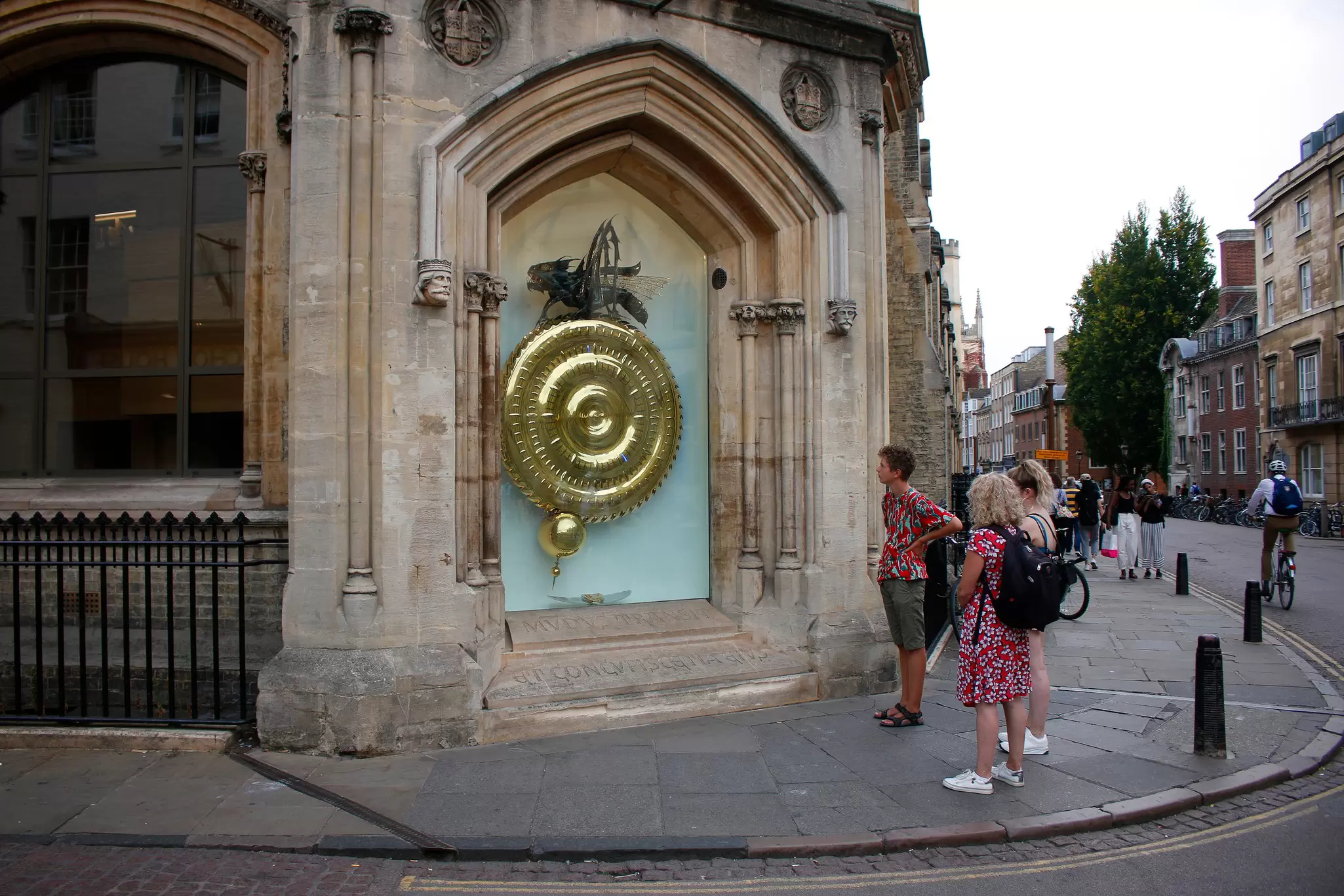 Visitors looking at the Corpus Clock at Cambridge University, UK.