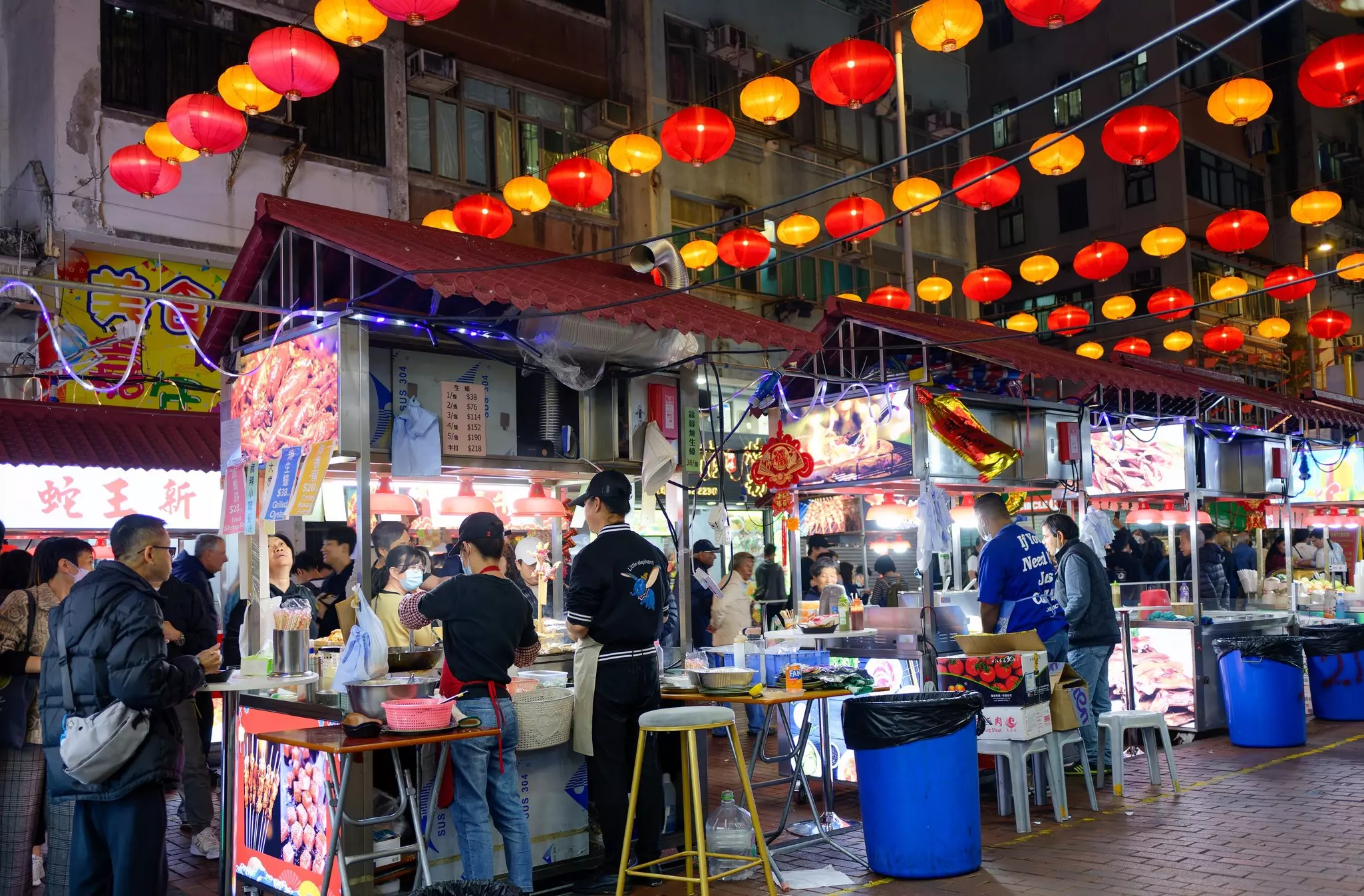Nighttime view of the famous street restaurants in Temple Street, Kowloon, Hong Kong.