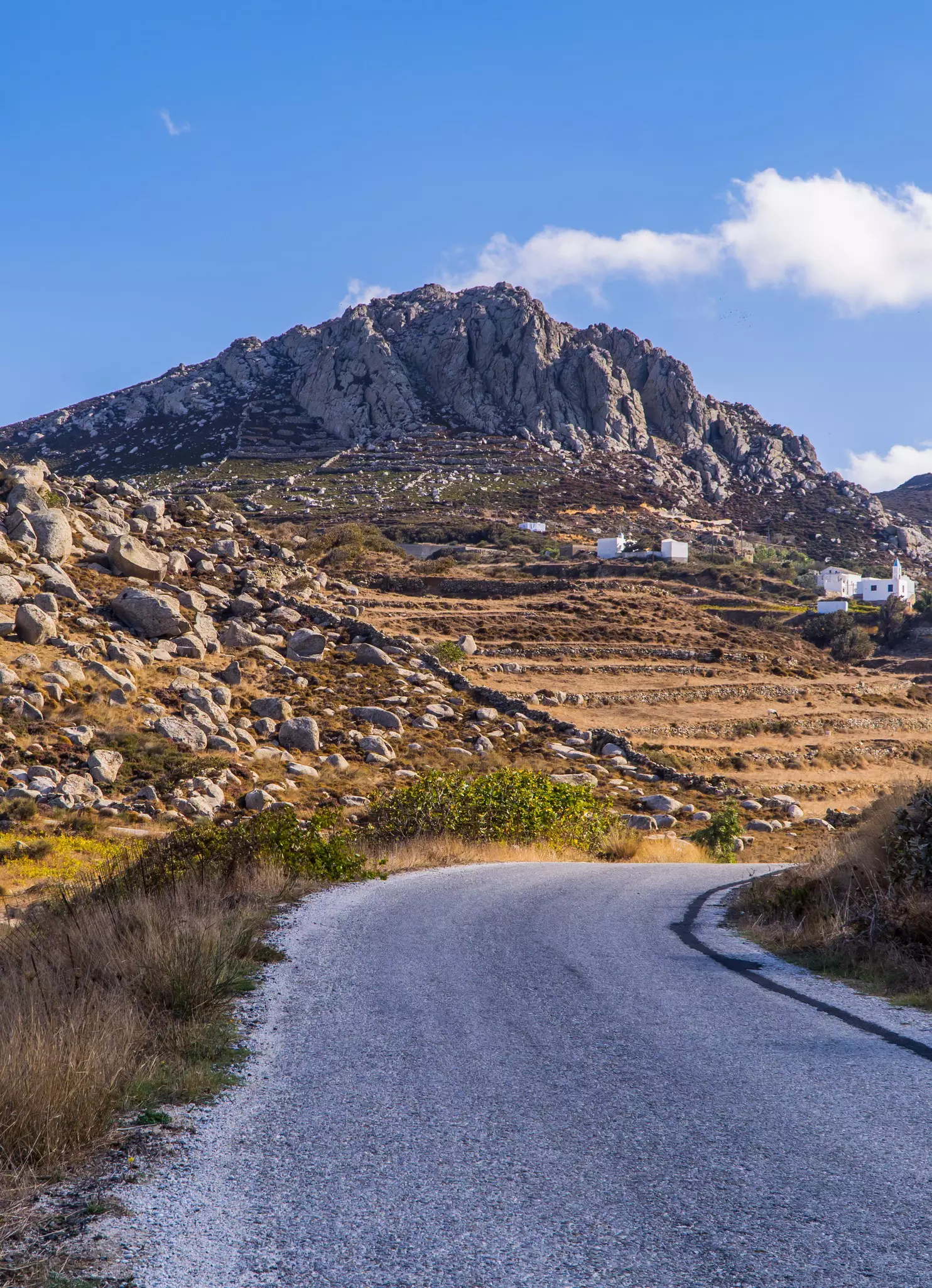 View of a road in the foothills of Mount Exomvourgo (also known as Exobourgo) on the island of Tinos in Greece.