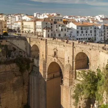 Aerial view of the Puente Nuevo spanning the 120m-deep chasm of El Tajo gorge, dividing the city of Ronda in Spain.