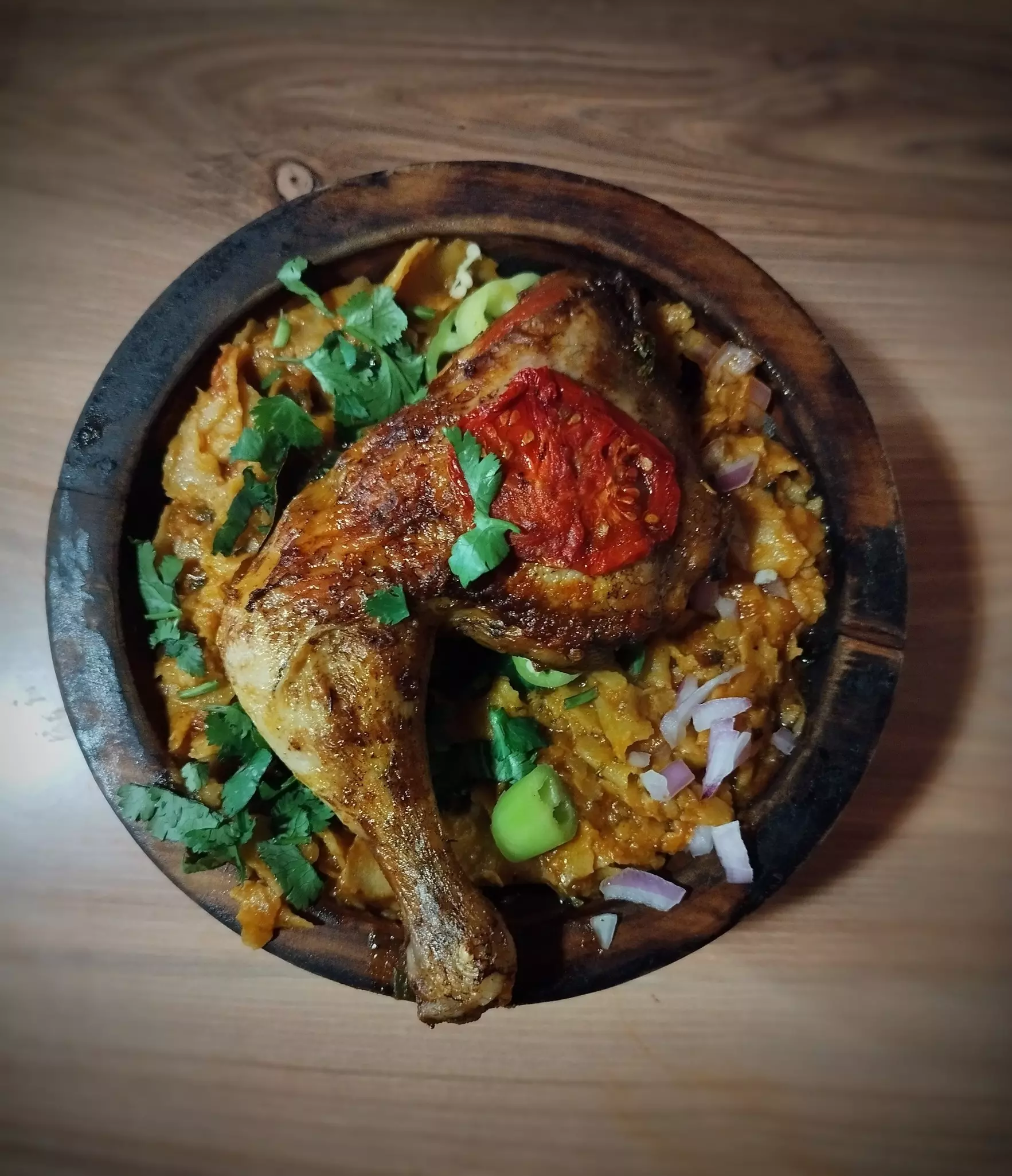 A spicy chicken dish with tomatoes and chillis.