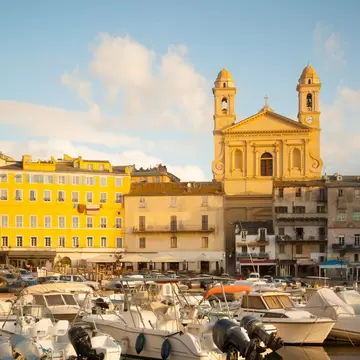 Scene of the old port (the Vieux Port) with the Église St-Jean-Baptiste in Bastia, Corsica, France.