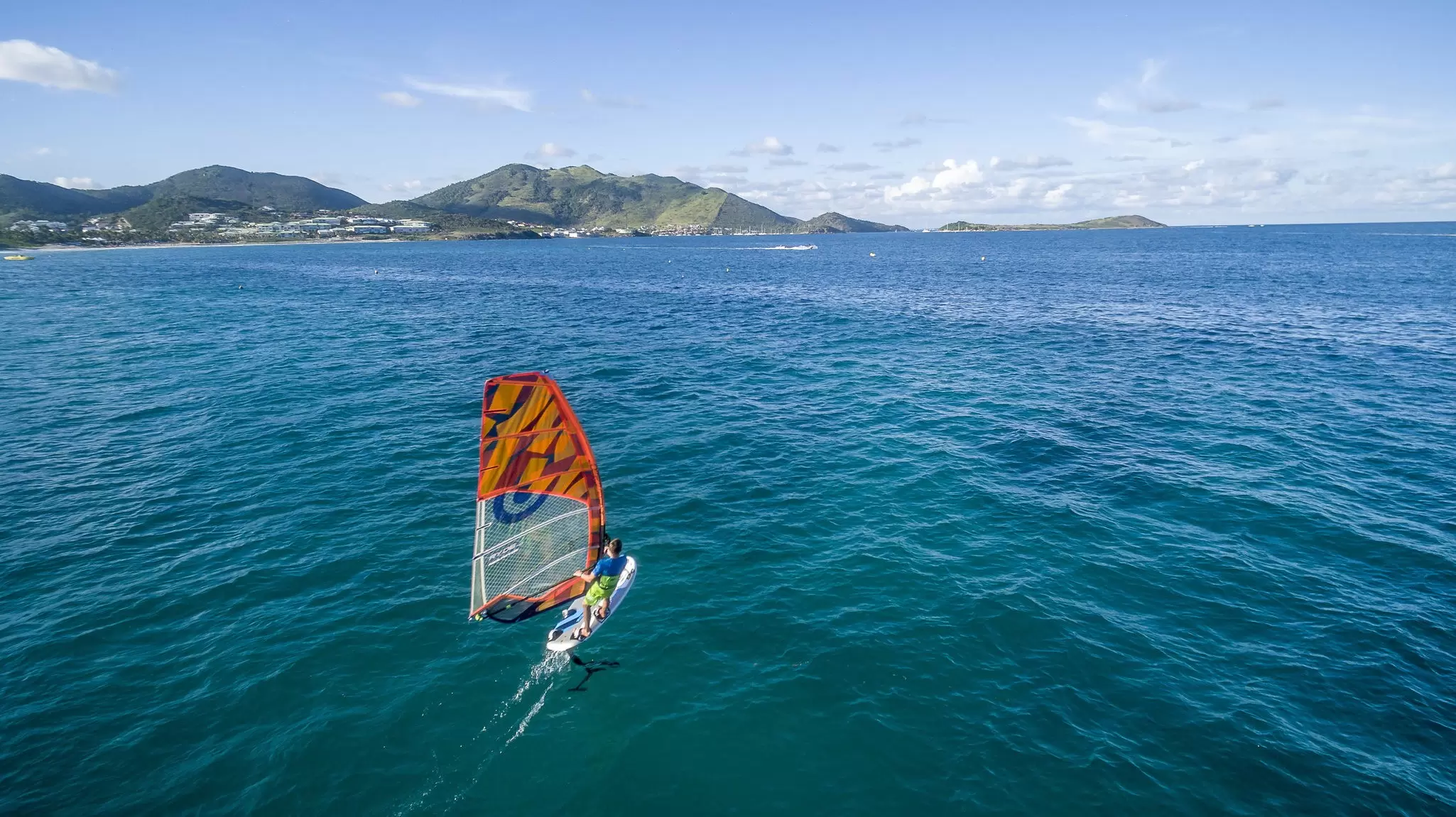 Kite-surfing off the coast of St-Martin Beach in the Caribbean. thierry dehove/Shutterstock