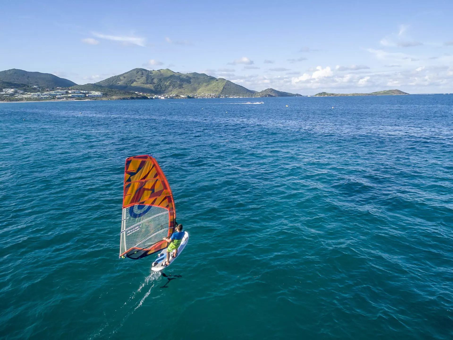 Kite-surfing off the coast of St-Martin Beach in the Caribbean. thierry dehove/Shutterstock