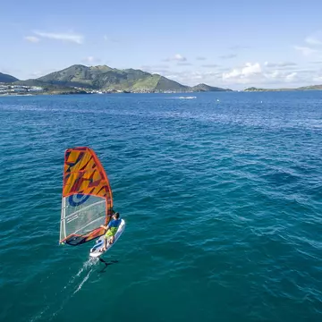 Kite-surfing off the coast of St-Martin Beach in the Caribbean. thierry dehove/Shutterstock