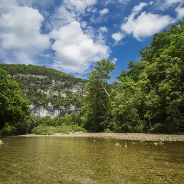 A view from the Buffalo River with a kayaker looking towards Big Bluff and the Goat Trail. Gunnar Rathbun/Shutterstock
