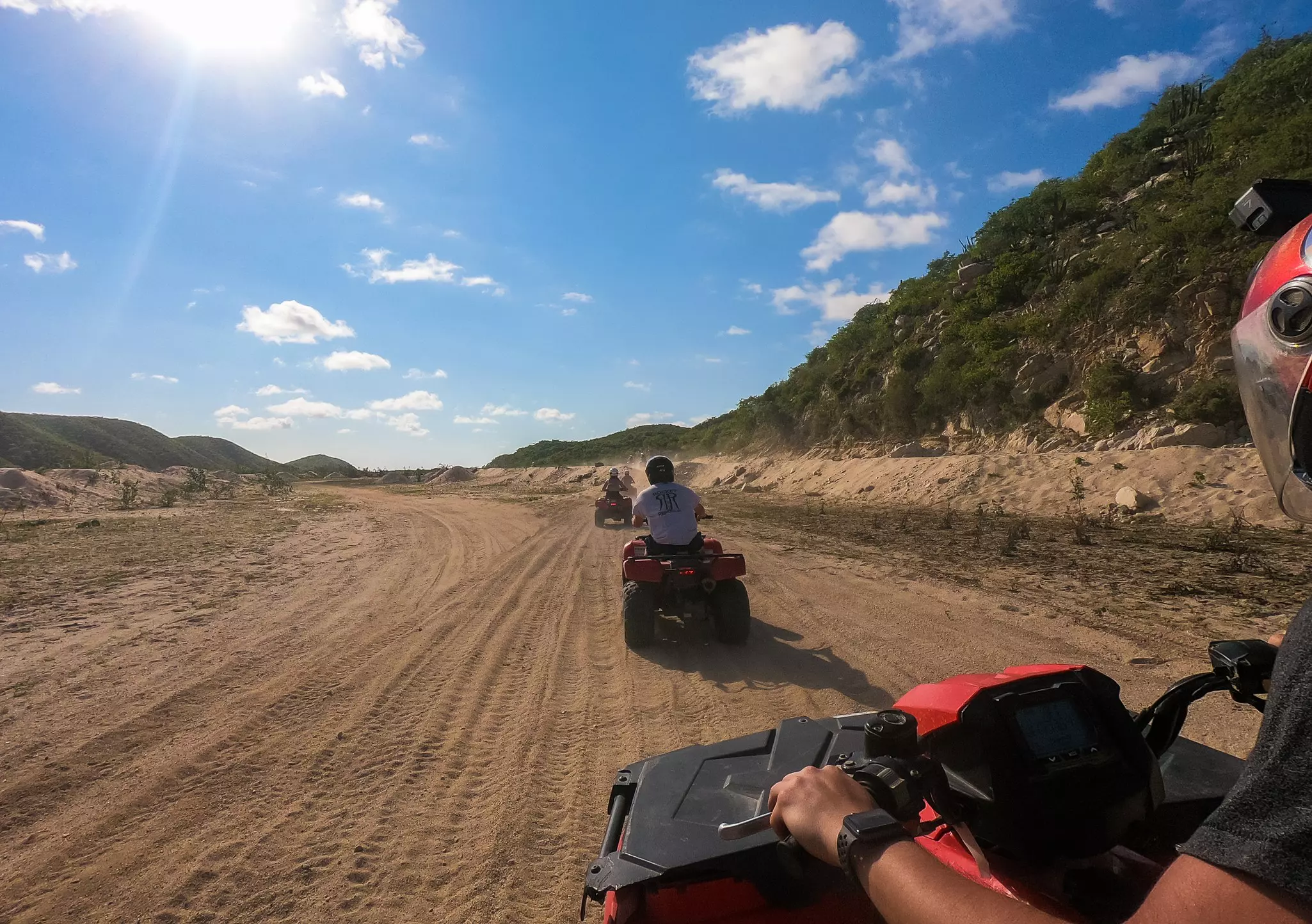 Tourists ride ATVs through the desert, an activity offered by various tour companies in Baja California Sur.