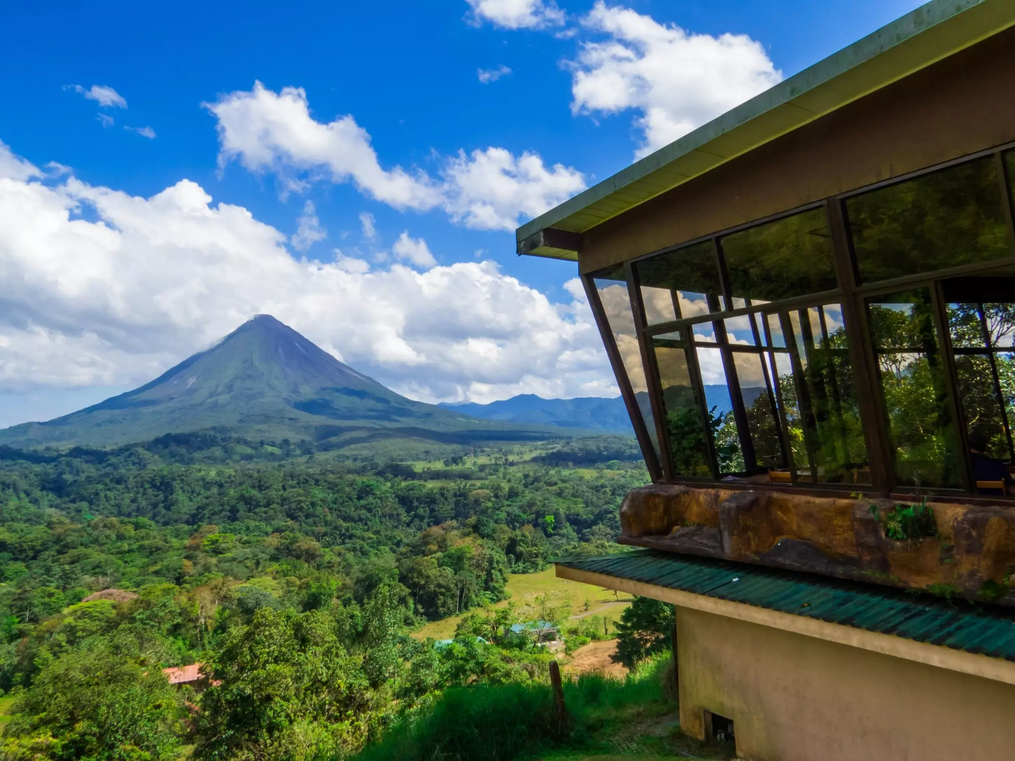 The perfect cone of a volcano surrounded by dense jungle